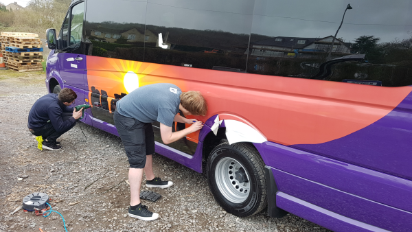 applying vinyl printed graphics to bus